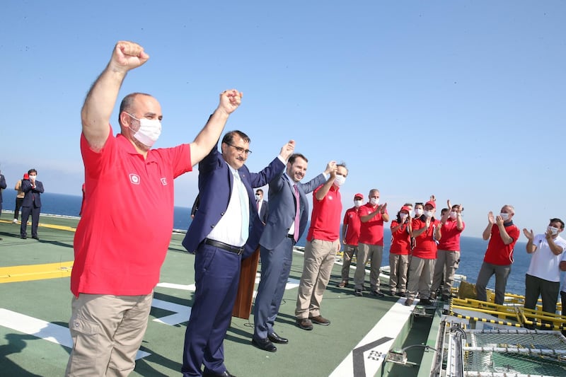 Turkish Finance Minister Berat Albayrak and Energy Minister Fatih Donmez pose with members of Turkish Petroleum (TPAO) on the deck of drilling vessel Fatih in the western Black Sea, off Turkey. REUTERS