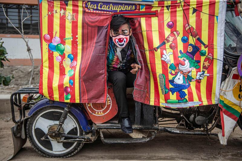 A clown wearing face mask poses for a picture before performing at Puente Piedra district, in the northern outskirts of Lima. Due to the coronavirus pandemic, circuses in Peru remain closed. AFP