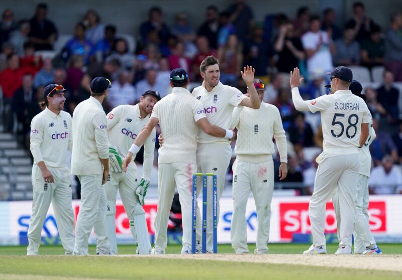 England bowler Craig Overton, centre, celebrates taking the wicket of India's Ravindra Jadeja for 30. AP