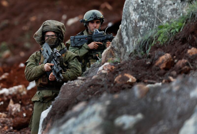 Israeli soldiers stand guard at the site of their excavation work. AP Photo