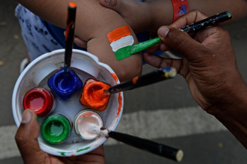 A fan of India gets tri-colours painted on the hands before the second Test between India and England outside the M.A. Chidambaram Cricket Stadium in Chennai. AFP