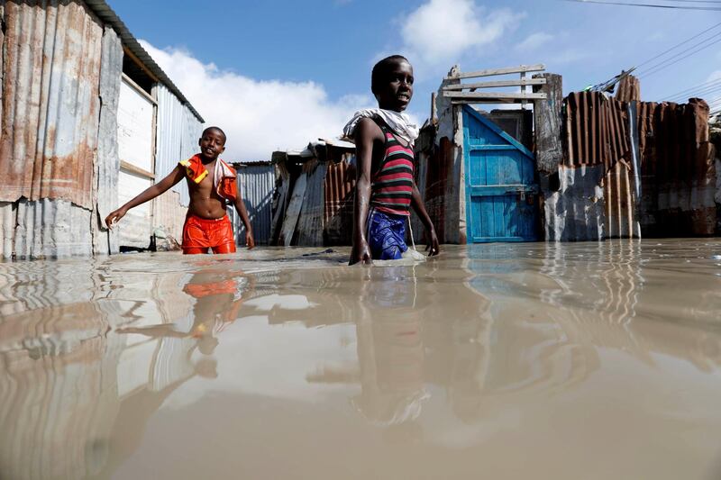 Somali children wade through flood waters after heavy rain in Mogadishu, Somalia. Reuters