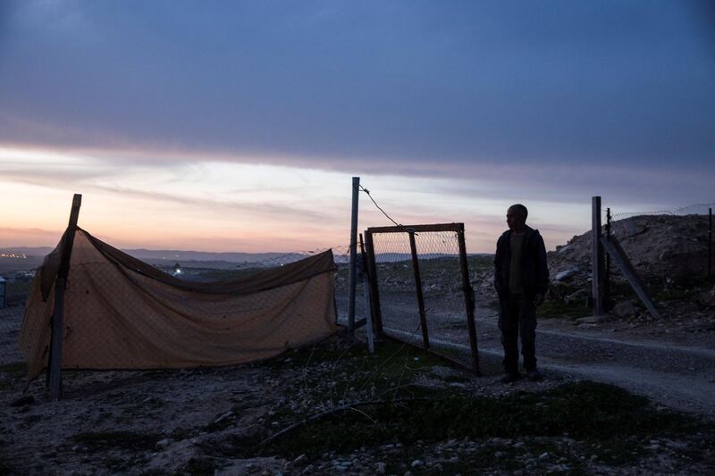 Ayad Gboha, a Bedouin father of seven children stand near the makeshift fence of his home at night in the  unrecognized village of al-Poraa and others near the city of Arad in the Negev Desert on February 24,2018. plan being discussed to build a giant phosphate mine which they fear could not only risk their health but force them to be evicted from where they have lived for generations .(Photo by Heidi Levine for The National).
