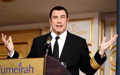 American actor John Travolta gestures as he answers a reporter's question during a news conference in Dubai, United Arab Emirates Monday, Sept. 9, 2013. Travolta is in Dubai on a week-long promotional tour for an airline. (AP Photo/Kamran Jebr