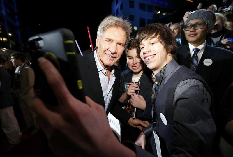 Actor Harrison Ford poses for a fan as he arrives at the premiere of Star Wars: The Force Awakens in Hollywood, California. Mario Anzuoni / Reuters 