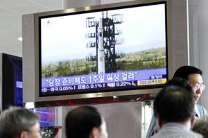 South Koreans watch a television showing a missile launch by North Korea at the Seoul Railway Station.