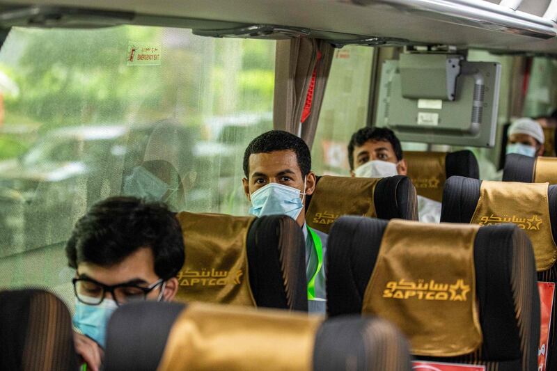 A handout picture provided by the Saudi Ministry of Hajj and Umra on July 25, 2020, shows travellers among the first group of arrivals for the annual Hajj pilgrimage, mask-clad and seated distantly from one another due to the COVID-19 coronavirus pandemic, riding on a bus transporting them from the Red Sea coastal city of Jeddah's King Abdulaziz International Airport. The 2020 hajj season, which has been scaled back dramatically to include only around 1,000 Muslim pilgrims as Saudi Arabia battles a coronavirus surge, is set to begin on July 29. Some 2.5 million people from all over the world usually participate in the ritual that takes place over several days, centred on the holy city of Mecca. This year's hajj will be held under strict hygiene protocols, with access limited to pilgrims under 65 years old and without any chronic illnesses. - === RESTRICTED TO EDITORIAL USE - MANDATORY CREDIT "AFP PHOTO / HO / MINISTRY OF HAJJ AND UMRA" - NO MARKETING NO ADVERTISING CAMPAIGNS - DISTRIBUTED AS A SERVICE TO CLIENTS ===
 / AFP / Saudi Ministry of Hajj and Umra / - / === RESTRICTED TO EDITORIAL USE - MANDATORY CREDIT "AFP PHOTO / HO / MINISTRY OF HAJJ AND UMRA" - NO MARKETING NO ADVERTISING CAMPAIGNS - DISTRIBUTED AS A SERVICE TO CLIENTS ===
