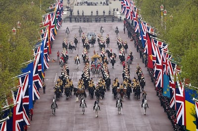The Diamond Jubilee State Coach, accompanied by the Sovereign's Escort of the Household Cavalry, on The Mall.