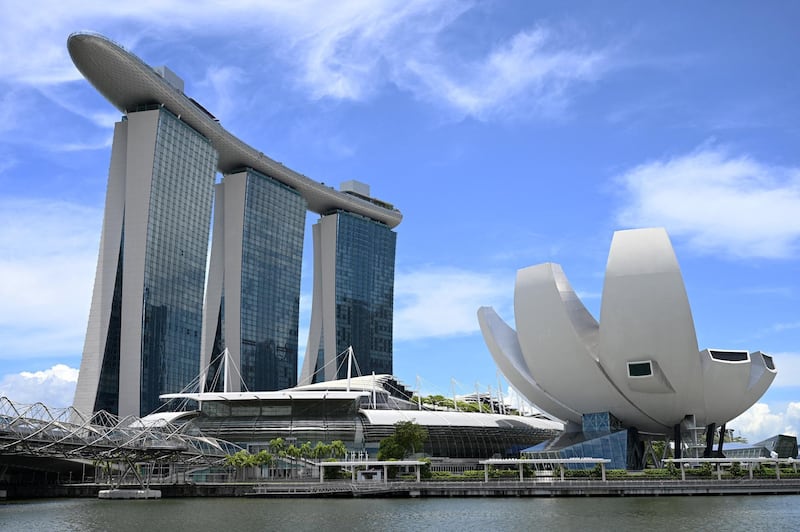 A general view of Marina Bay Sands hotel and resort (L) and the ArtScience Museum (R) are seen in Singapore on March 26, 2021. (Photo by Roslan RAHMAN / AFP)