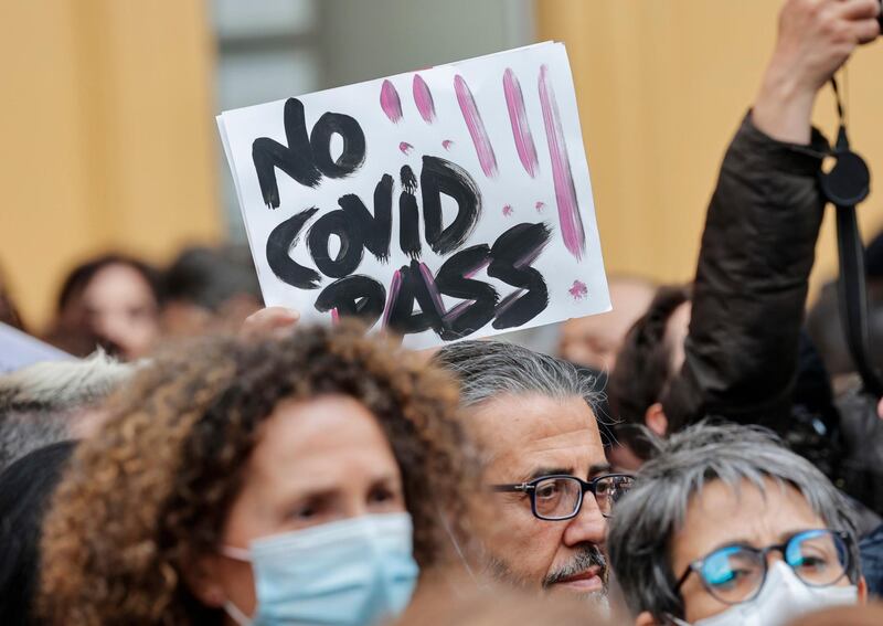 People take part in a protest against vaccines next to the Chamber of Deputies in piazza Montecitorio, in Rome, Italy. EPA