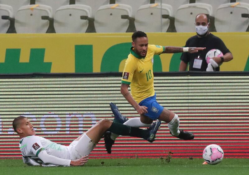 Brazil's Neymar, right, is fouled by Bolivia's Leonardo Zabala. AP