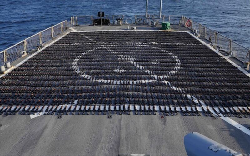 The confiscated rifles laid out on the deck of the destroyer