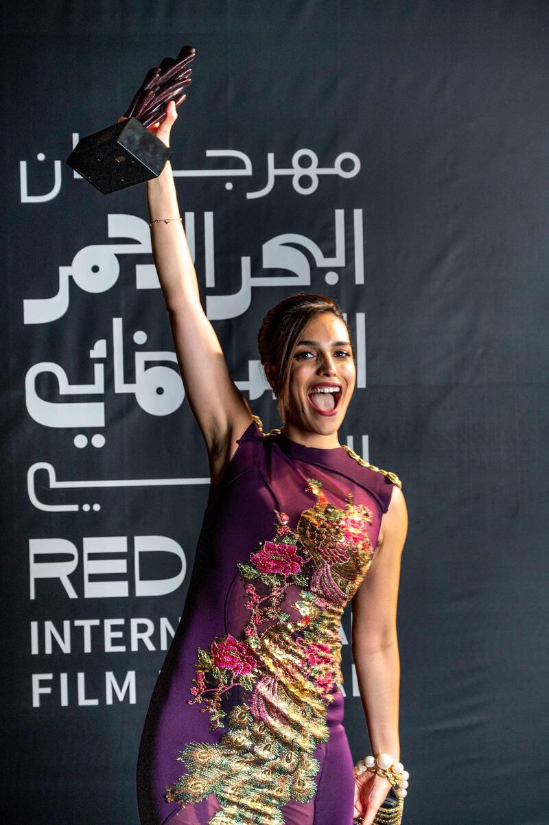 US-Egyptian film director Dina Amer poses with the Audience Award for 'You Resemble Me'. Photo: Red Sea International Film Festival / AFP