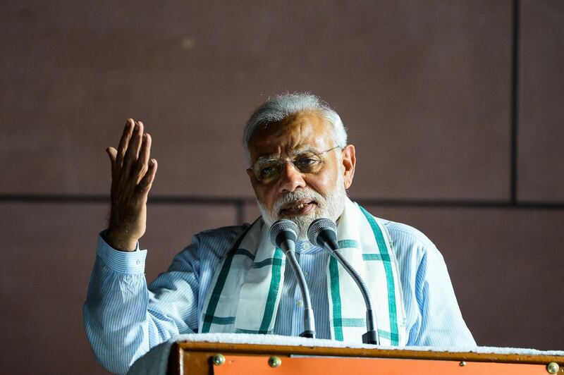 Indian Prime Minister Narendra Modi addresses party supporters during a celebration event ahead of wining the Karnataka election in New Delhi on May 15, 2018. India's opposition Congress party suffered an electoral setback May 15 in one of the last major states which it governs and scrambled to build a coalition to stop Prime Minister Narendra Modi's party taking over. Modi's Bharatiya Janata Party (BJP) won most seats in Karnataka but fell short of a clear majority in the state of 60 million people, which includes the wealthy global IT hub of Bangalore. / AFP / CHANDAN KHANNA
