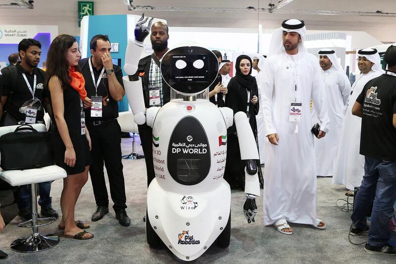 Visitors look at a 3D printed robot at the DP World stand. Pawan Singh / The National