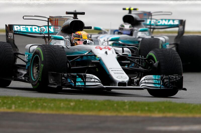 Mercedes driver Lewis Hamilton of Britain takes a curve followed by teammate Valtteri Bottas of Finland during the qualifying session for the British Formula One Grand Prix at the Silverstone racetrack in Silverstone, England, Saturday, July 15, 2017. The British Formula One Grand Prix will be held on Sunday, July 16. (AP Photo/Frank Augstein)