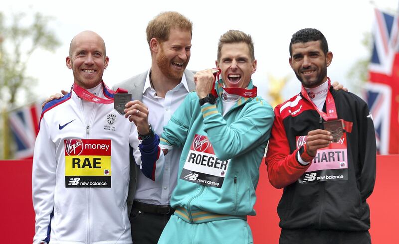 LONDON, ENGLAND - APRIL 28: Derek Rae of Great Britain (2nd), Michael Roger of Australia (1st) and Abdehadi El Harti of Morocco (3rd) all celebrate their respective finishing positions in the T46 Men's race with Prince Harry, Duke of Sussex during the 2019 Virgin Money London Marathon in the United Kingdom on April 28, 2019 in London, England. (Photo by Naomi Baker/Getty Images)