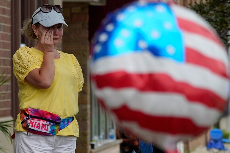 A woman cries following the shooting. AP