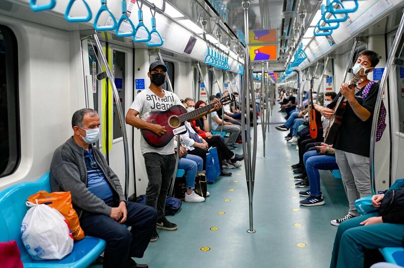 Amateur musicians play in the Istanbul metro during a performance ban due to the Covid-19 sanitary restrictions in Istanbul. AFP