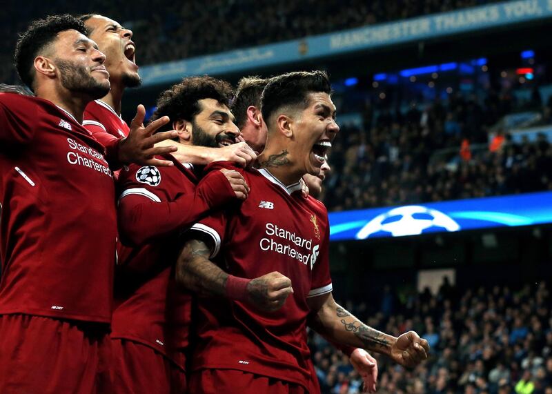 epa06660298 Liverpool's Roberto Firmino (R) celebrates with his teammates after scoring the 2-1 lead during the UEFA Champions League quarter final second leg match between Manchester City and FC Liverpool in Manchester, Britain, 10 April 2018.  EPA/Nigel Roddis