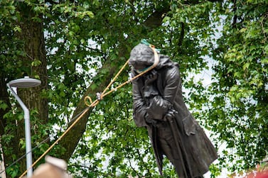 The statue of Edward Colston falls down as protesters pull it down, following the death of George Floyd who died in police custody in Minneapolis, in Bristol, Britain, June 7. Picture taken June 7. Keir Gravil / via REUTERS 