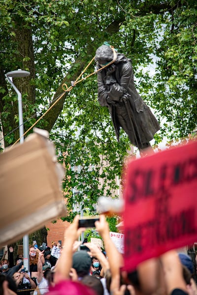 The statue of Edward Colston falls down as protesters pull it down, following the death of George Floyd who died in police custody in Minneapolis, in Bristol, Britain, June 7, 2020. Picture taken June 7, 2020. Keir Gravil/via REUTERS THIS IMAGE HAS BEEN SUPPLIED BY A THIRD PARTY. MANDATORY CREDIT.