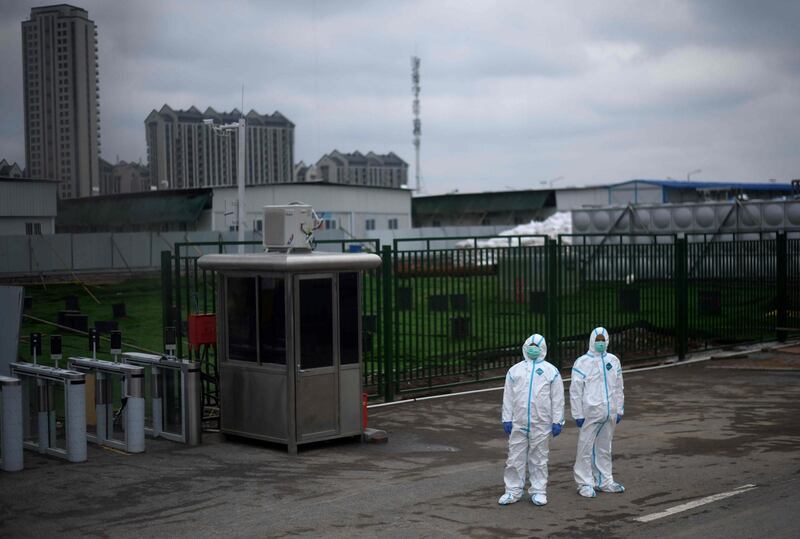 Security personnel wearing hazmat suits stand in front of the Wuhan Leishenshan Hospital in Wuhan, in China’s central Hubei province.   AFP