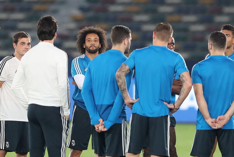 Abu Dhabi, United Arab Emirates - December 21, 2018: Marcelo of Real Madrid listens to his manager ahead of the Fifa Club World Cup final. Friday the 21st of December 2018 at the Zayed Sports City Stadium, Abu Dhabi. Chris Whiteoak / The National