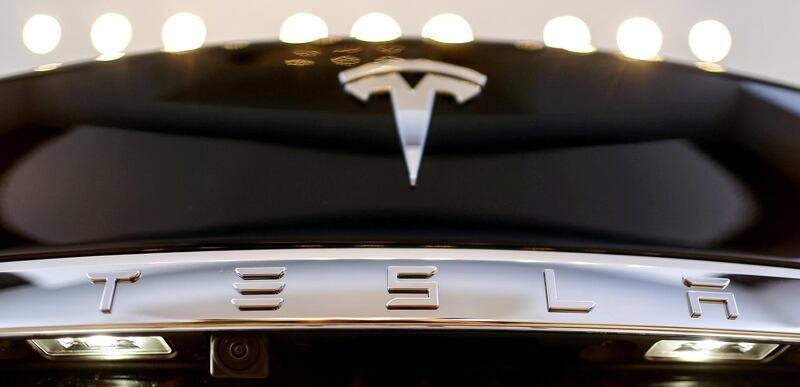 FILE PHOTO: A Tesla logo adorns a 'Model S' car in the dealership in Berlin, Germany, November 18, 2015. REUTERS/Hannibal Hanschke/File Photo