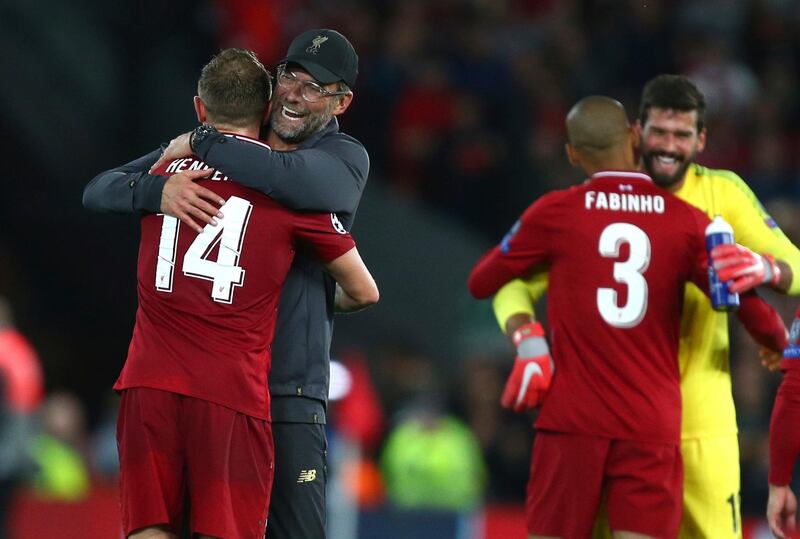 Liverpool's coach Juergen Klopp hugs Liverpool's Jordan Henderson after the Champions League Group C soccer match between Liverpool and Paris-Saint-Germain at Anfield stadium in Liverpool, England, Tuesday, Sept. 18, 2018. Liverpool won the match 3-2. (AP Photo/Dave Thompson)