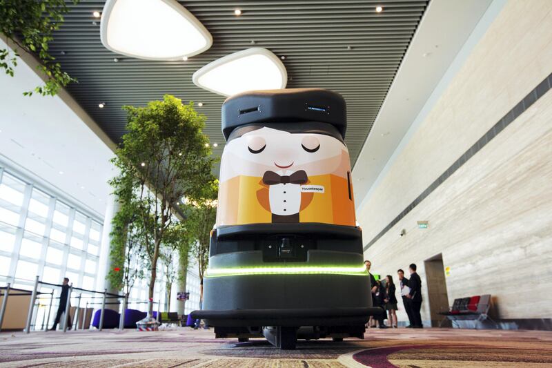 An automated robotic cleaner travels along the departure hall during a media preview of the new Terminal 4 (T4) at Changi Airport in Singapore, on Tuesday, July 25, 2017. The terminal which will open later this year, will feature an array of ���fast and seamless travel��� (FAST) technologies to speed people-processing without the need for human supervision, from face-recognition software to automated bag-tagging and checking. Photographer: Nicky Loh/Bloomberg