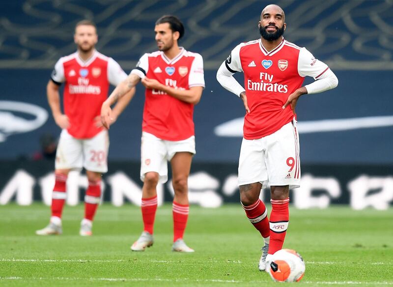 Dejected Arsenal players after Tottenham's late goal. AFP