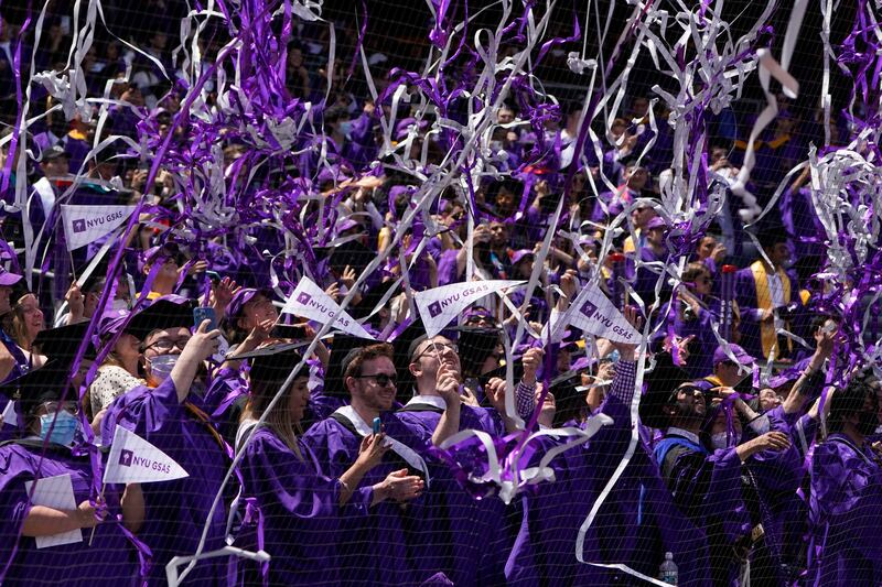 Confetti drops on graduates as they celebrate during a graduation ceremony for New York University at Yankee Stadium. AP