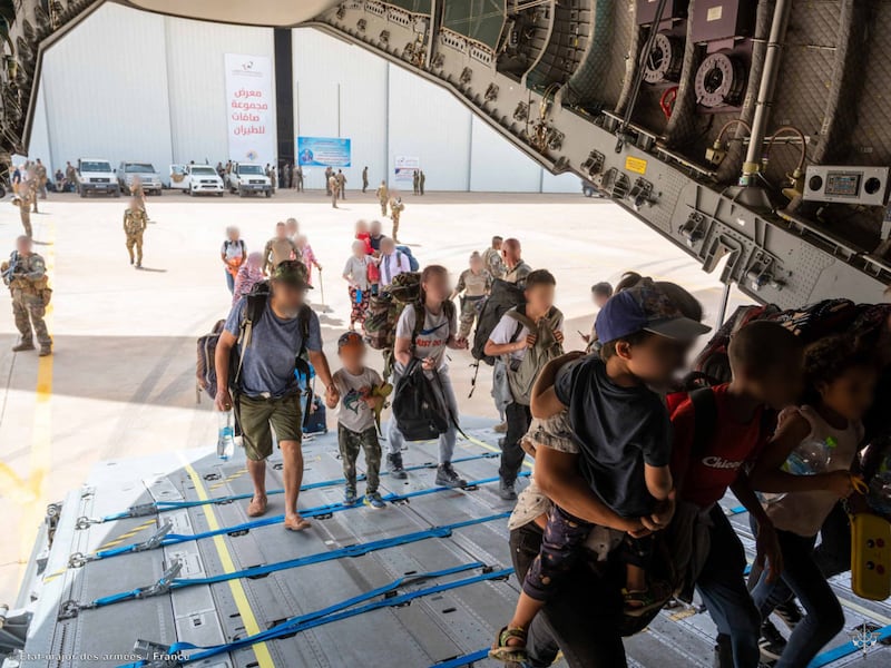 Foreign citizens board a plane at a French military air base in Khartoum to leave Sudan on April 23. AFP