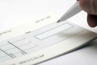 A blank cheque ready for signing. Banks in the Gulf could seek mergers as a way of offsetting pressure on revenues, ratings agency Moody's said. istockphoto.com