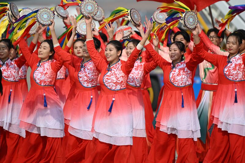 Performers dance as Argentina's President Alberto Fernandez arrives at Beijing's international airport. Getty Images
