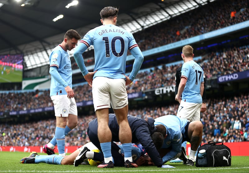 City midfielder Ilkay Gundogan receives treatment after a challenge by Max Killman of Wolves. Getty