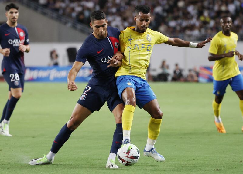Achraf Hakimi of PSG battles for the ball with Abdulrahman Ghareeb. EPA