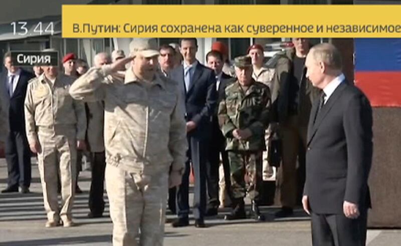 In this Monday, Dec. 11, 2017 frame grab made available by Russian Rossiya 24 TV Channel Sergei Surovikin, Russian Commander in Syria, 3rd left, reports to President Vladimir Putin, right, as Syrian President Bashar Assad, 4th left, listens, at the Hemeimeem air base in Syria. Declaring a victory in Syria, Putin on Monday visited a Russian military air base in the country and announced a partial pullout of Russian forces from the Mideast nation (Rossiya 24 TV Channel photo via AP)