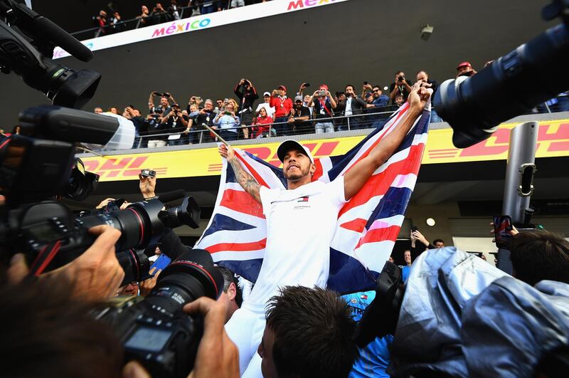 MEXICO CITY, MEXICO - OCTOBER 28:  2018 F1 World Drivers Champion Lewis Hamilton of Great Britain and Mercedes GP celebrates with his team after the Formula One Grand Prix of Mexico at Autodromo Hermanos Rodriguez on October 28, 2018 in Mexico City, Mexico.  (Photo by Clive Mason/Getty Images)