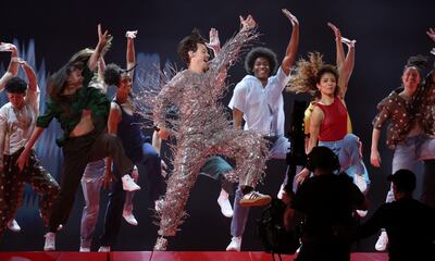 Harry Styles performs at the Grammy Awards in silver Gucci. Reuters