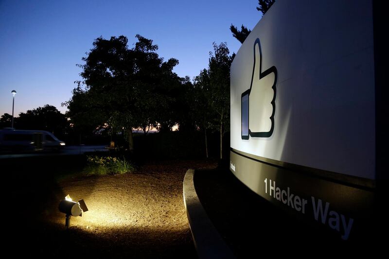 FILE- In this Jun 7, 2013, file photo, the Facebook "like" symbol is illuminated on a sign outside the company's headquarters in Menlo Park, Calif. Facebook says it is making progress on deleting hate speech, graphic violence and other violations of its rules, including detecting them before they are seen by users. The company released its second report Thursday, Nov. 15, 2018, detailing how it enforces community standards banning hate, nudity and other content. (AP Photo/Marcio Jose Sanchez, File)