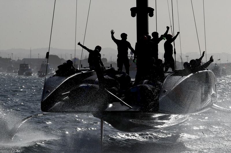 Emirates Team New Zealand members celebrate after winning the American's Cup against Luna Rossa Prada Pirelli Team at Auckland Harbour on Wednesday, March 17. Getty