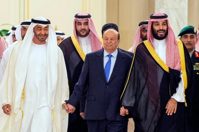 Sheikh Mohamed bin Zayed walks with Mr Hadi and Prince Mohammed bin Salman at the ceremony. AFP