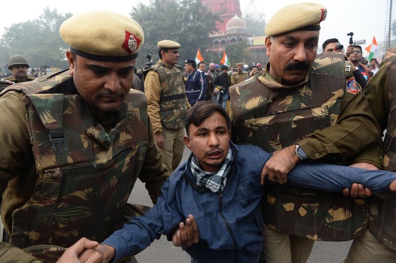 Police detain a protester at a demonstration against India’s new citizenship law in New Delhi on December 19, 2019. Big rallies are expected across India on December 19 as the tumultuous and angry reaction builds against a citizenship law seen as discriminatory against Muslims.
 / AFP / Sajjad HUSSAIN                      
