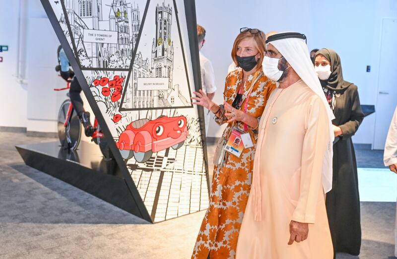 An official gives Sheikh Mohammed a tour of the Belgium pavilion.
