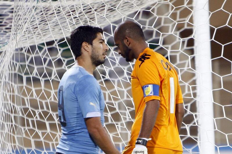 Oman goalkeeper Ali Al Habasii walks past Luis Suarez during their international friendly on Monday. Mohammed Mahjoub / AFP / October 13, 2014