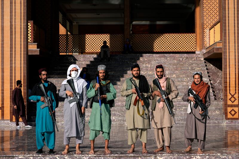 Taliban fighter stand guard outside a mosque at the start of Eid Al Fitr in Kabul. AP