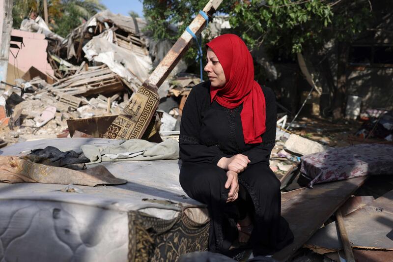 A woman sits amid the rubble of her house at Nusseirat refugee camp in Gaza, which was damaged during days of deadly fighting between Israel and the Palestinian Islamic Jihad militant group. AFP