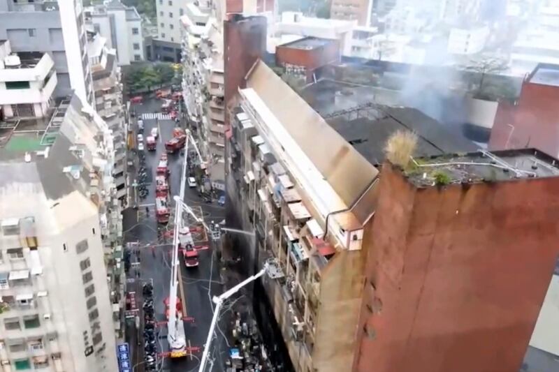 In this image taken from a video by Taiwan's EBC, firefighters shoot water into a building that caught fire in Kaohsiung, southern Taiwan. AP Photo